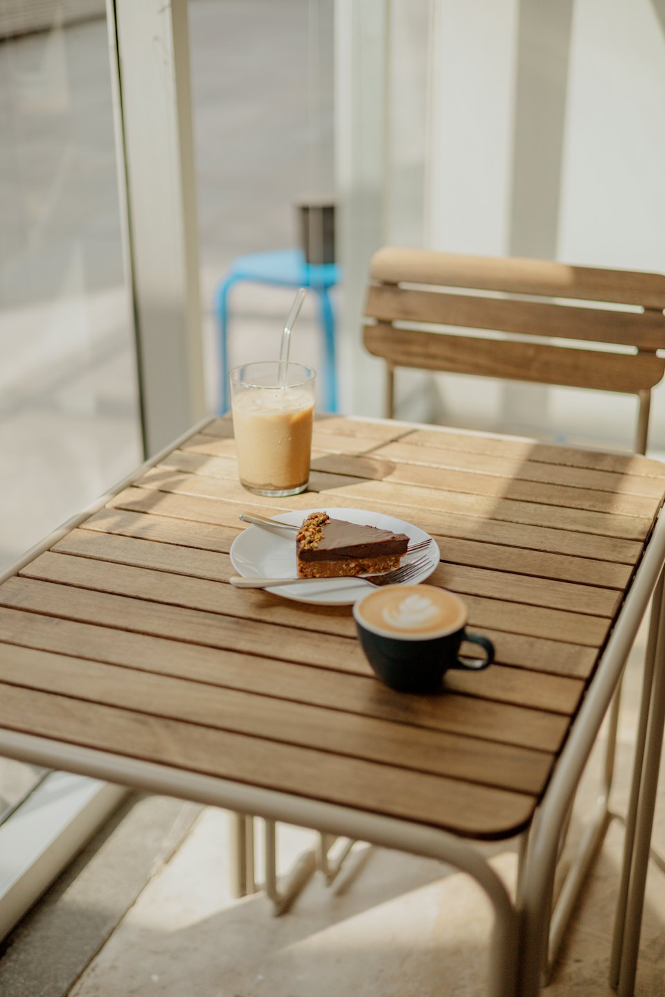 Chocolate nut cake and coffee on a wooden table.