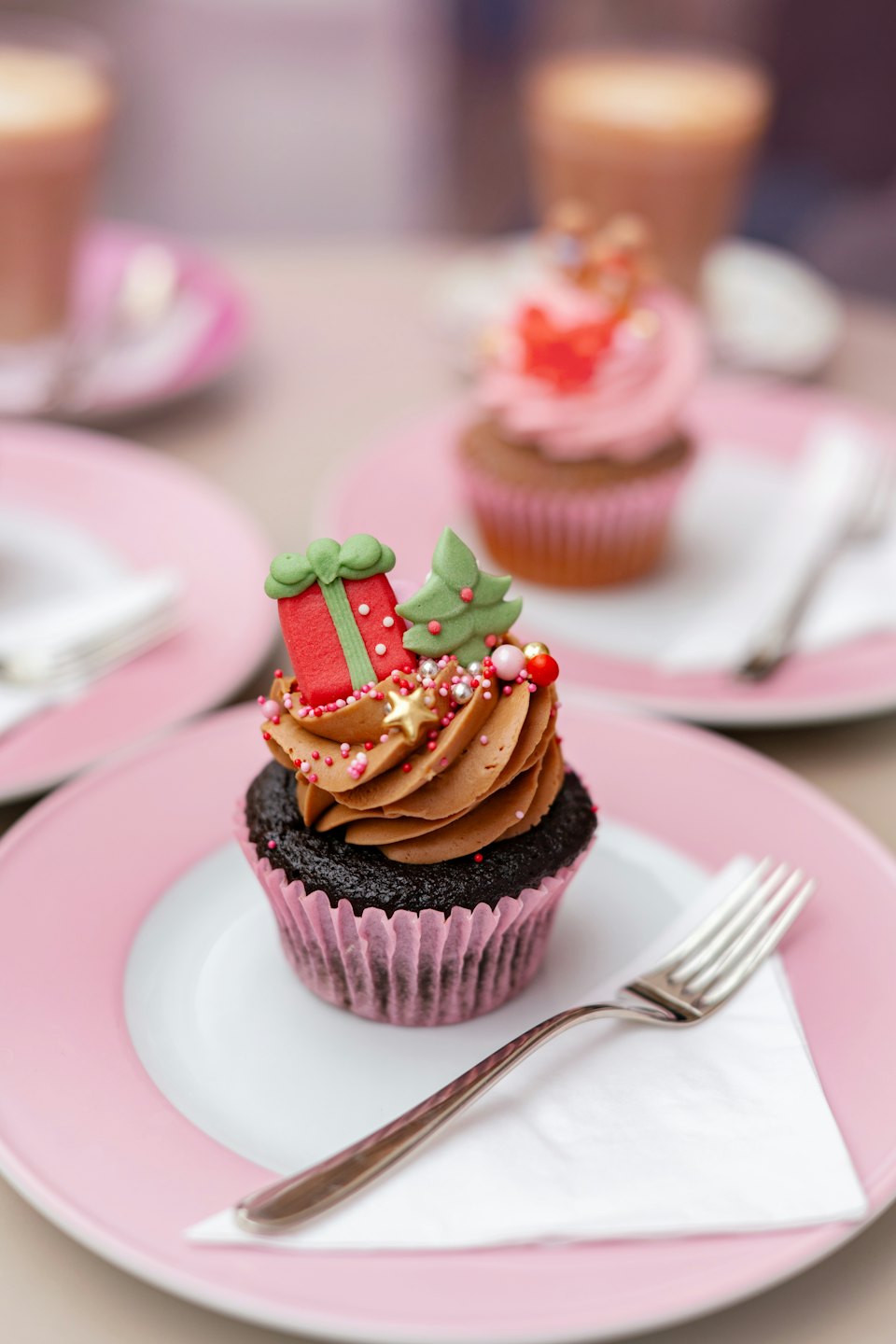 Christmas cupcake with festive decorations on a white plate.